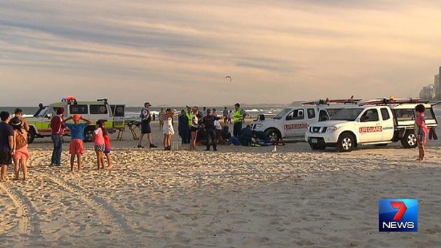 Lifeguards tend to a pair who were run over at Surfers Paradise.