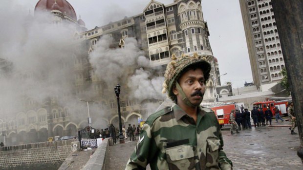 The Taj Hotel burns after gun battles between Indian troops and militants in Mumbai on Saturday.