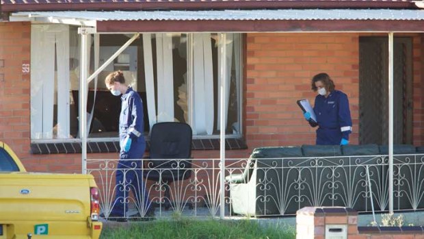 Police examine the house in Deer Park.