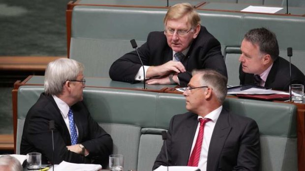 Labor MP Kevin Rudd in discussion with backbenchers during Question Time, at Parliament House.