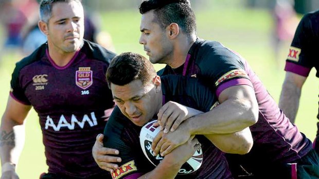 Queensland Maroons ... Josh Papalii runs into the defence during a recent State of Origin training session.