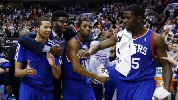 Philadelphia 76ers players  Michael Carter-Williams, Nerlens Noel, Hollis Thompson and Henry Sims celebrate in the final seconds of the win over Detroit.