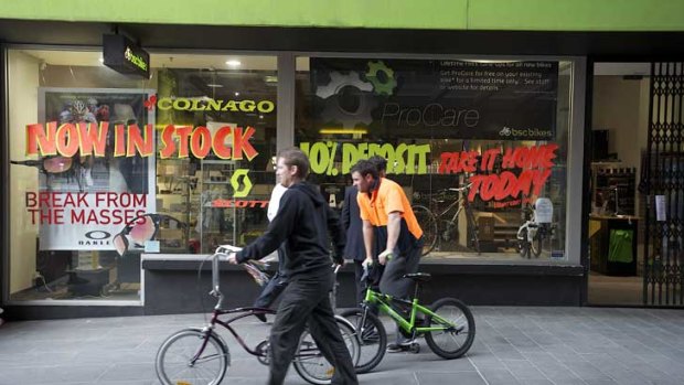 Employees remove stock from BSC Bikes' QV Building store in the city yesterday.