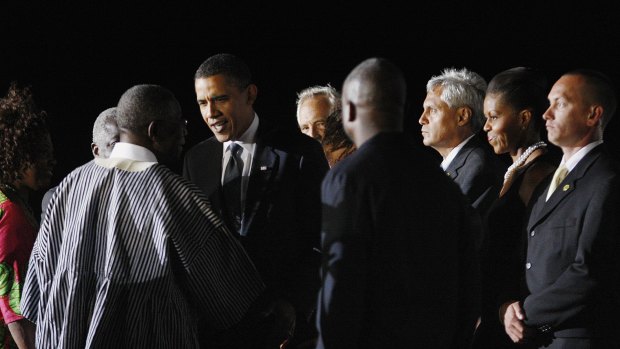 US President Barack Obama greets Ghanaian President John Atta Mills upon arrival in Accra.