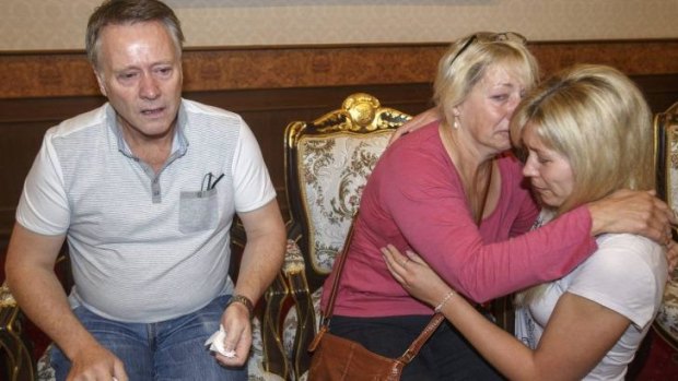 Family members of Hannah Witheridge, one of the two British tourists killed on Koh Tao island, comfort each other at the headquarters of the Royal Thai Police in Bangkok.