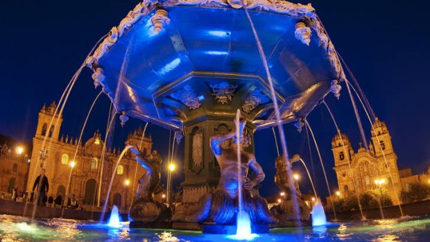 The lit fountain in Plaza de Armas, Cusco.