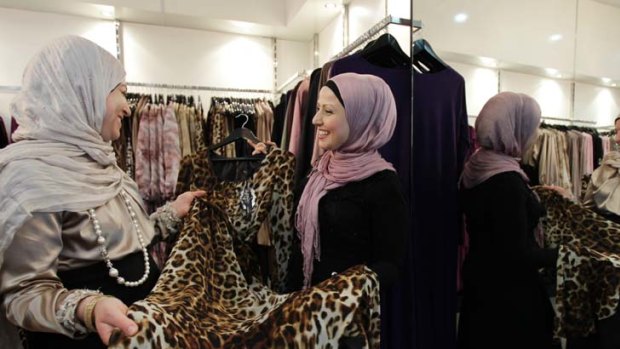 Festive mood ... Howayda Moussa, who set up Integrity Boutique along with her sister, assists customer Amal Yasin.
