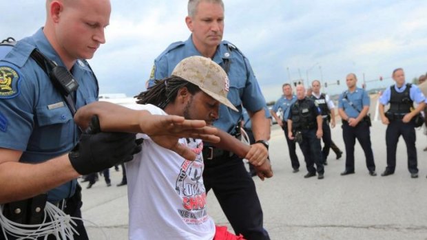 A man is arrested during a protest at Hanley Road and Interstate 70 during an attempt to shut down Interstate 70 in Berkeley, Missouri.