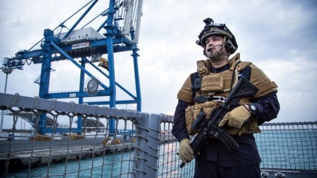 A guard stands on the Norwegian frigate Helge Ingstad, part of the Danish-Norwegian force that will transport Syria's chemical agents out of the country to destruction. 