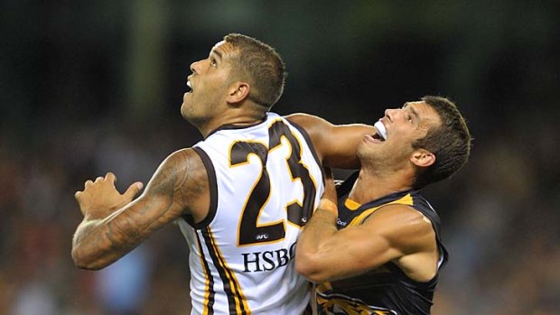Eyes up: Lance Franklin (left) and Alex Rance go for the ball.