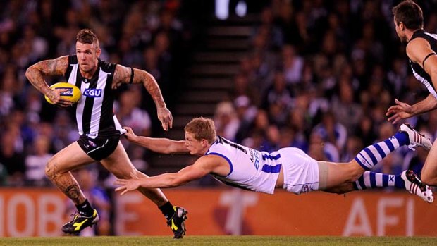 Tagger: North's Jack Ziebell tries to cling to Collingwood's Dane Swan.