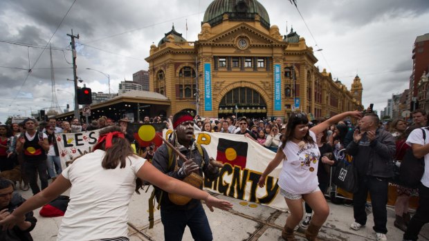 Hundreds of Invasion Day protesters march at the back of the Australian Day Parade in Melbourne's CBD.