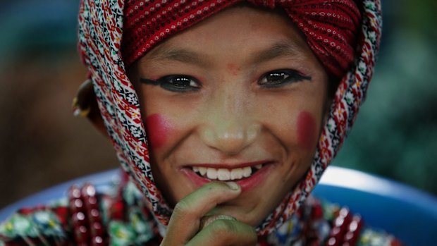 A Nepalese boy gets ready to perform a stick dance during a rally held to pay tribute to the victims of an earthquake, in Bhaktapur, Nepal, Wednesday, Sept 2, 2015. Two powerful earthquakes in April and May devastated the Himalayan nation killing more than 8,800 people. (AP Photo/Niranjan Shrestha)