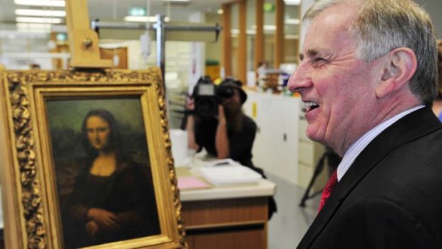 Arts Minister Simon Crean inspects a copy of the famous painting the Mona Lisa at the National Library of Australia, Canberra.