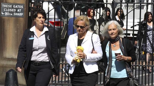 Joan Harnum with a doll believed to be her murdered daughter's at court for the decision.