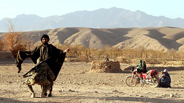 A man is searched at an Australian and Afghan National Army checkpoint near the patrol base in Musazai in Oruzgan province.