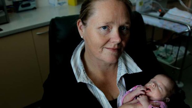 ''A traumatic condition'' ... Kristy Herd, with five-week-old daughter Hayley in Nepean Hospital yesterday, had pre-eclampsia - which can kill mother and child - in all three of her pregnancies.