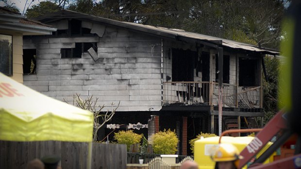 The gutted house in which eleven people are feared dead.