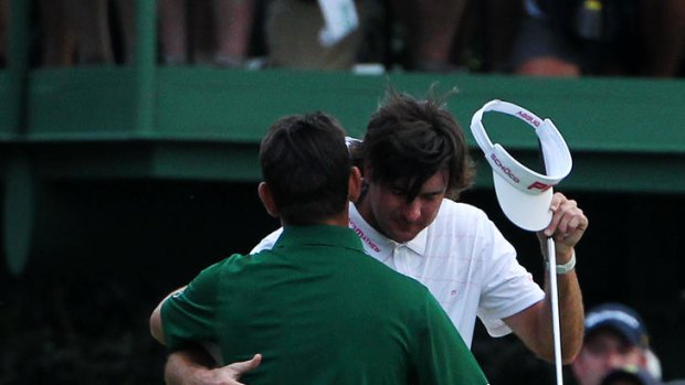 Champion ... Bubba Watson, right, hugs Louis Oosthuizen after winning the Masters.