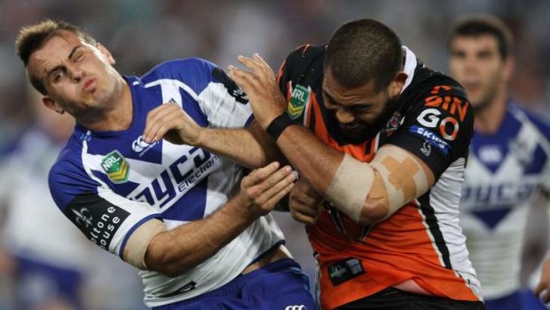 Shoulder to shoulder: Dogs five-eighth Josh Reynolds cops a big hit from Adam Blair.