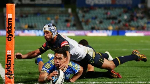 In the corner: Ken Sio slides over to score for the Eels.