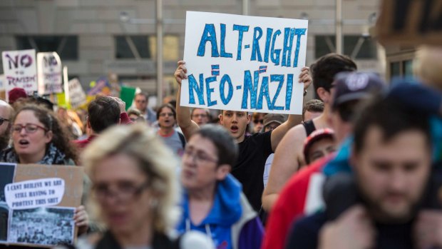 Protesters march outside a conference of the so-called alt-right in Washington.