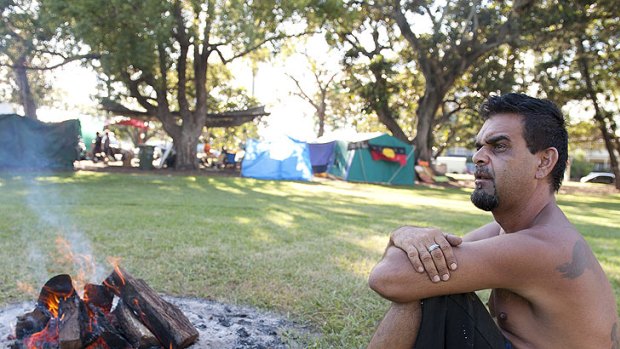 Jason Harrison sits near the Sacred Fire at the Musgrave park tent Embassy, Brisbane, March 31, 2012.