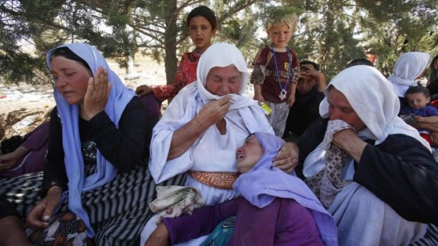 A Yazidi family mourns the death of a family member.