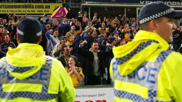 The police watch on as Eels fans cheer during Friday night's game against the Storm.