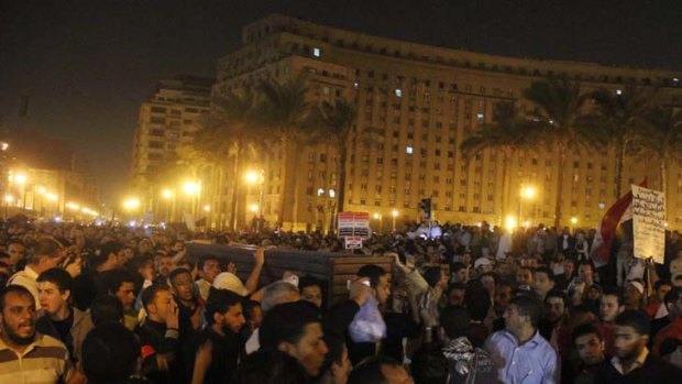 Uproar ... protesters carry the coffin of Essam Atta, 24, in Cairo.