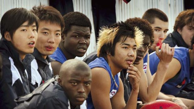 Footy stars ... players from around the world in Melbourne, including 16-year-old Balinese footballer Komang Sulaya, centre, dyed hair, at the South Pacific vs World XVIII match this week.