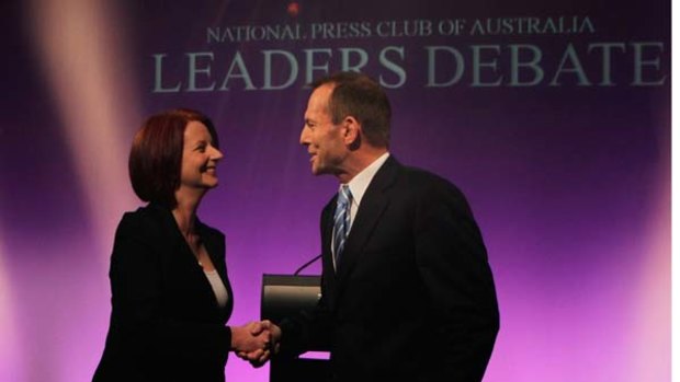 Head to head ... Julia Gillard and Tony Abbott shake hands before yesterday's debate in Canberra.