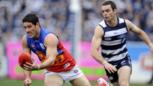 Matthew Scarlett chases after Brendan Fevola, who kicked only one goal against the Cats.