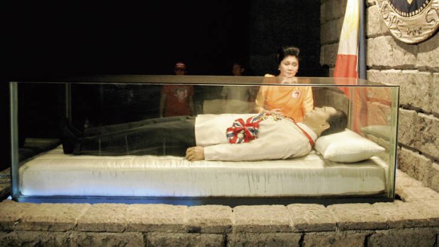 I see dead people … Imelda Marcos beside her late husband Ferdinand’s glass coffin.