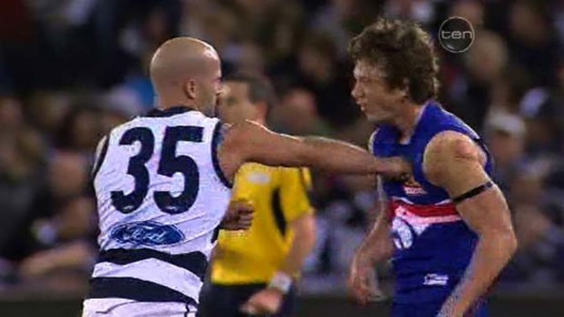 Ouch. Liam Picken feels the brunt of a Paul Chapman hit.