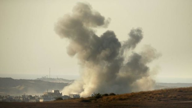 Smoke rises from Palestinian houses following an Israeli military strike on the Israeli-Gaza border.