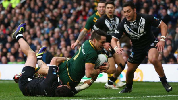 And over: Cooper Cronk of Australia scores after scooping up a kick by Darius Boyd.