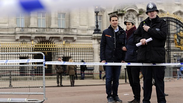 Taped off ... outside Buckingham Palace after a man armed with two knives was stunned by police.