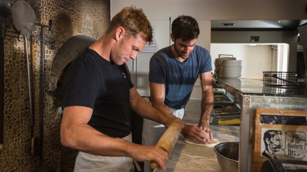 Boyle demonstrates the art of pizza making.