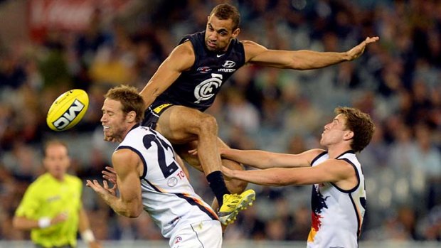 Perched nicely: Carlton's Chris Yarran climbs on the back of Adelaide defender Ben Rutten at the MCG.