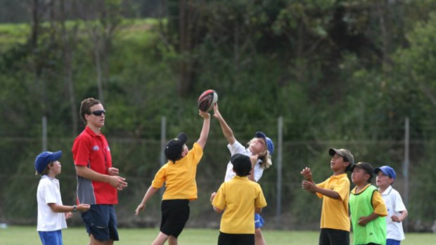 ''Focus is on having fun'' … children play AFL in Narrabeen last week. Auskick AFL has dispensed with scores and awards for children aged five to 12.