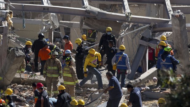 Rescue workers comb through the rubble of the children's hospital, which collapsed after the tanker explosion.