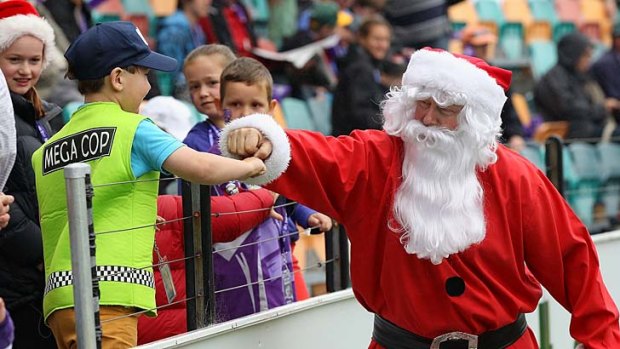 Santa entertains the waiting crowd.