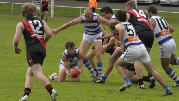 Casterton captain Dylan Ryan attempts to find a teammate with a handball.