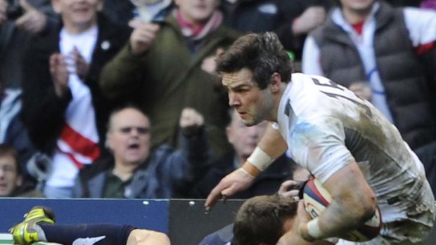 England fullback Ben Foden is tackled by his oppositie number Chris Paterson.