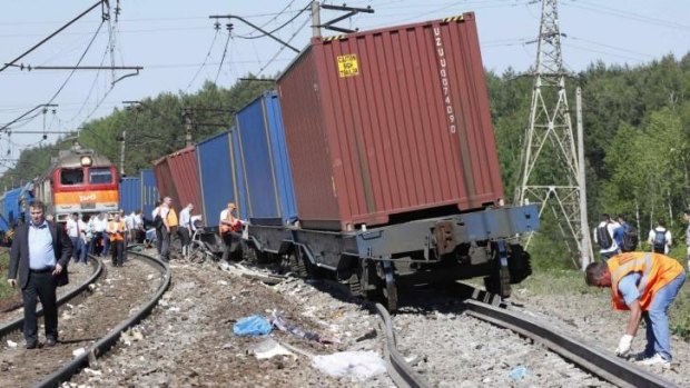 The investigation begins ... Repair services and Russian Railways employees and investigators gather near the site of a train collision near Moscow.
