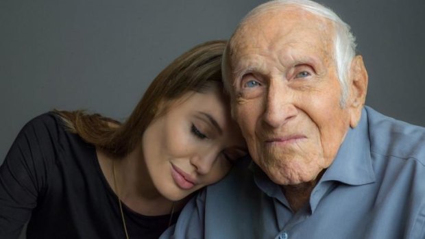 Olympian-turned-WWII prisoner of war Louis Zamperini with <i>Unbroken</i> director Angelina Jolie before he died in July.