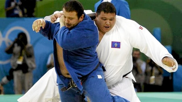 Ricardo Blas Jr (white) competes in the men's heavyweight division in judo at the Beijing Olympics.