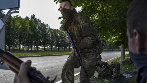 Pro-Russian militia take defensive positions as shelling erupts near Sergei Prokofiev International Airport in Donetsk, eastern Ukraine. 