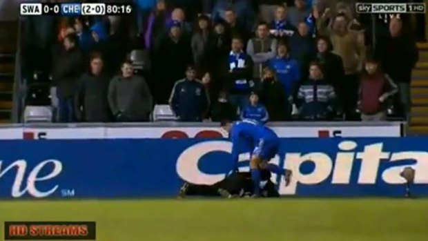 Controversy ... Eden Hazard pulls his foot back before kicking out at the ballboy.